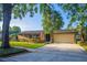 Charming single-story brick home with a well-manicured lawn and a spacious driveway leading to an attached two-car garage at 2108 Cree Trl, Casselberry, FL 32707