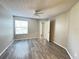 A well-lit bedroom features a ceiling fan and wood-look floors, creating a cozy and inviting space at 2608 Grassy Point Dr # 102, Lake Mary, FL 32746