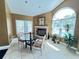 Cozy breakfast nook with a fireplace and large windows offering plenty of natural light at 2608 Grassy Point Dr # 102, Lake Mary, FL 32746