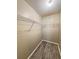 A walk-in closet features neutral walls, wood-look floors, and ample metal shelving for maximum storage at 2608 Grassy Point Dr # 102, Lake Mary, FL 32746