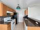 Cozy kitchen with wood cabinets, stainless steel appliances, and tile backsplash, perfect for casual dining at 2608 Grassy Point Dr # 102, Lake Mary, FL 32746