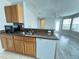 Charming kitchen seamlessly flows into the living area, featuring modern countertops, stainless sink and appliances at 2608 Grassy Point Dr # 102, Lake Mary, FL 32746
