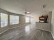 Inviting living space with views from large windows, modern flooring, ceiling fan and kitchen access at 2608 Grassy Point Dr # 102, Lake Mary, FL 32746