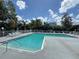 Community pool with lounge chairs and lush foliage at 2608 Grassy Point Dr # 102, Lake Mary, FL 32746