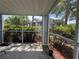 A screened in porch looks out onto lush shrubbery, creating a serene outdoor space at 2608 Grassy Point Dr # 102, Lake Mary, FL 32746