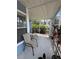 A screened in porch with two tan chairs looks out onto lush shrubbery at 2608 Grassy Point Dr # 102, Lake Mary, FL 32746