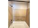 Neutral shower over tub combo with toiletry shelving at 2608 Grassy Point Dr # 102, Lake Mary, FL 32746