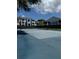 Enjoy a match on the community tennis court with well-maintained surface and surrounding landscaping at 2608 Grassy Point Dr # 102, Lake Mary, FL 32746