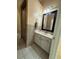 Well lit bathroom featuring a glass enclosed shower and marble countertop vanity with black hardware at 330 Sweetwater Springs St, Debary, FL 32713