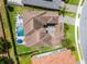Aerial view of a luxury home showcasing its swimming pool, spa and spacious outdoor living at 3863 Grassland Loop, Lake Mary, FL 32746