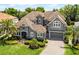 Aerial shot of a home showcasing its tile roof, lush landscaping and expansive outdoor living area at 3863 Grassland Loop, Lake Mary, FL 32746