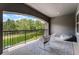Covered balcony offering views of lush greenery with chairs and a beanbag for relaxing at 3863 Grassland Loop, Lake Mary, FL 32746
