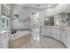 Bright bathroom features a soaking tub, tiled floors, and a double vanity with granite countertops at 3863 Grassland Loop, Lake Mary, FL 32746