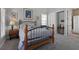 Cozy bedroom featuring a metal frame bed and an artsy design with warm bedside lighting at 3863 Grassland Loop, Lake Mary, FL 32746