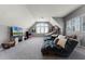 Comfortable bonus room with large couch, tv, and large windows offering plenty of natural light at 3863 Grassland Loop, Lake Mary, FL 32746