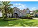 Attractive home with a lush lawn, tropical palm, and a brick paver driveway at 3863 Grassland Loop, Lake Mary, FL 32746