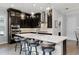 Modern kitchen with a large center island, pendant lighting, dark cabinets, and stainless steel appliances at 3863 Grassland Loop, Lake Mary, FL 32746