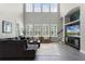 Bright living room featuring high ceilings, neutral tones, large windows, and wood look floors at 3863 Grassland Loop, Lake Mary, FL 32746