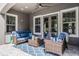 Inviting outdoor patio with comfortable seating, stylish rug, and french doors at 3863 Grassland Loop, Lake Mary, FL 32746