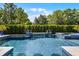 Stunning mosaic tiled pool with water features, integrated spa, and lush privacy landscaping at 3863 Grassland Loop, Lake Mary, FL 32746