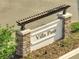 Stone and stucco community entrance sign reading 'Villa Pass' surrounded by landscaping at 6564 Rhythm Dr, Mascotte, FL 34753