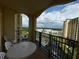 Condo balcony with seating and views of a resort pool and green landscape, ideal for relaxing in the Florida sun at 8125 Resort Village Dr # 51006, Orlando, FL 32821