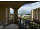 Enjoy resort views from this condo balcony overlooking landscaping, a pool, and neighboring buildings at 8125 Resort Village Dr # 51006, Orlando, FL 32821
