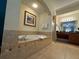 Bathroom suite featuring an integrated tub, walk-in shower, and double sink vanity at 8125 Resort Village Dr # 51006, Orlando, FL 32821