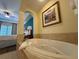 Bathroom suite featuring an integrated tub, walk-in shower, and double sink vanity with archway to bedroom at 8125 Resort Village Dr # 51006, Orlando, FL 32821