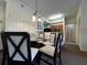 Well-lit dining area with a glass table, contemporary chairs, and view of the kitchen at 8125 Resort Village Dr # 51006, Orlando, FL 32821