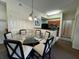 Bright dining space featuring a glass-top table with cushioned seating adjacent to the kitchen at 8125 Resort Village Dr # 51006, Orlando, FL 32821