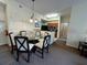 Cozy dining area features a glass table with seating for four next to kitchen and hallway at 8125 Resort Village Dr # 51006, Orlando, FL 32821