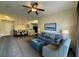 Inviting living room featuring a comfortable sofa, armchair, stylish decor, and a ceiling fan at 8125 Resort Village Dr # 51006, Orlando, FL 32821