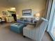 Comfortable living room with a sofa, armchair, modern decor, and plenty of natural light at 8125 Resort Village Dr # 51006, Orlando, FL 32821