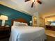 Comfortable bedroom with wooden headboard, bedside tables, lamps, and ensuite bathroom access at 8125 Resort Village Dr # 51006, Orlando, FL 32821