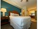 Comfortable bedroom with king bed, ceiling fan and access to ensuite bathroom at 8125 Resort Village Dr # 51006, Orlando, FL 32821