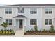 Charming townhome with a welcoming front porch, complemented by neatly manicured landscaping and neutral exterior paint scheme at 1291 Tarflower Dr, Winter Springs, FL 32708