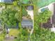 Overhead view of the property showcasing the house, detached garage, and verdant yard at 1299 Harding Street, Winter Park, FL 32789