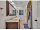 Classic bathroom featuring dual sinks with a walk-in shower at 1299 Harding Street, Winter Park, FL 32789