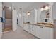 Bathroom featuring double granite top vanities and a walk-in shower at 1299 Harding Street, Winter Park, FL 32789