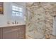 Bathroom featuring a stand up shower, sink and gray cabinet at 1299 Harding Street, Winter Park, FL 32789
