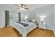 Bright bedroom with hardwood floors, ceiling fan, and shuttered windows at 1299 Harding Street, Winter Park, FL 32789