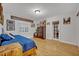 Bright bedroom with wooden floors, comfy bed, and lots of natural light from a door and windows at 1299 Harding Street, Winter Park, FL 32789