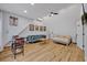 Spacious bonus room with vaulted ceilings, comfortable furniture, bed and wood flooring at 1299 Harding Street, Winter Park, FL 32789