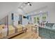 Bright bonus room with vaulted ceiling, access to balcony, with bed, couch, and wooden floors at 1299 Harding Street, Winter Park, FL 32789