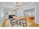 Bright dining room with natural light, a modern table, and stylish chandelier, ideal for Gathering meals and gatherings at 1299 Harding Street, Winter Park, FL 32789