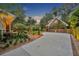 Beautiful property with a manicured lawn, mature trees, and a detached two-car garage at 1299 Harding Street, Winter Park, FL 32789