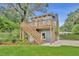 Two-story detached garage with a wood staircase leading to an upper deck at 1299 Harding Street, Winter Park, FL 32789