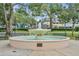 Community fountain surrounded by walking path and park benches at 1299 Harding Street, Winter Park, FL 32789