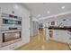 Well-lit kitchen featuring modern stainless steel appliances and light wood floors at 1299 Harding Street, Winter Park, FL 32789